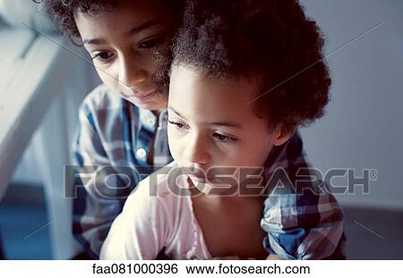 Stock Photograph - Young brother and sister, portrait. Fotosearch