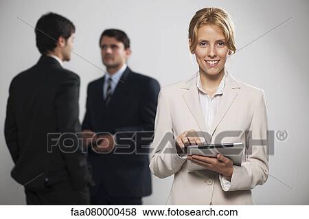 Stock Photo - Young businesswoman using digital tablet, portrait. Fotosearch