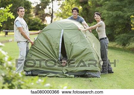 Stock Photograph - Young campers camping on field. Fotosearch