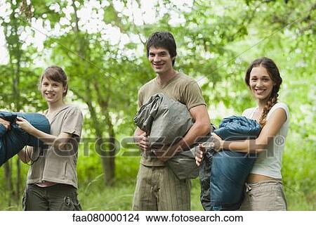 Young campers holding sleeping bags View Large Photo Image Picture - Young campers holding sleeping bags. Fotosearch