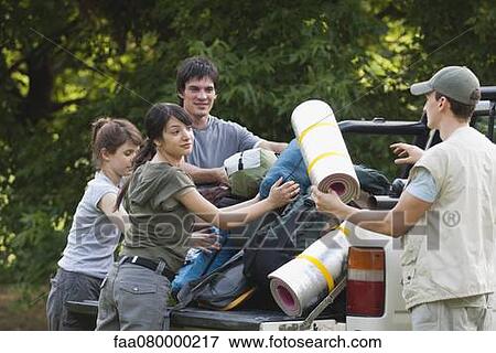 Young campers loading camping gear onto back of pick-up truck View Large Photo Image Stock Photo - Young campers loading camping gear onto back of pick-up truck. Fotosearch