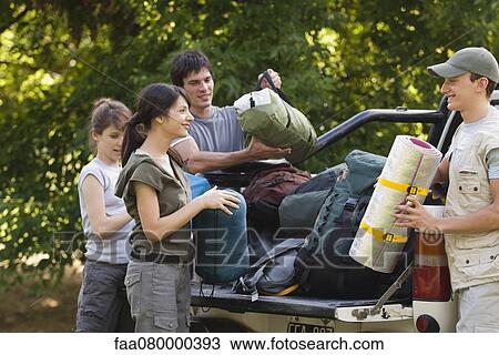 Young campers unloading camping gear from back of pick-up truck View Large Photo Image Stock Image - Young campers unloading camping gear from back of pick-up truck. Fotosearch