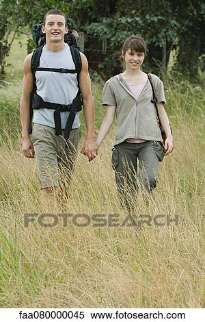 Young couple going for hike, holding hands View Large Photo Image Stock Photography - Young couple going for hike, holding hands. Fotosearch