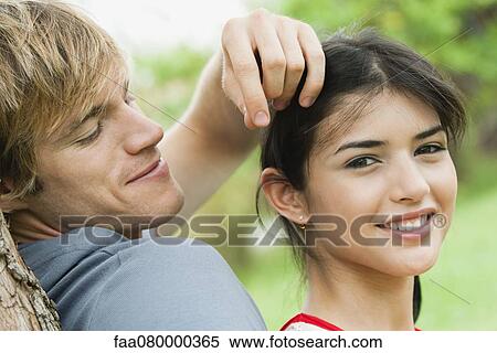 Stock Photography - Young couple together outdoors, portrait. Fotosearch