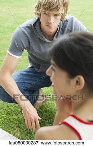 Young man hanging out outdoors with female friend View Large Photo Image Stock Photo - Young man hanging out outdoors with female friend. Fotosearch