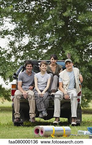 Stock Photograph - Young travelers sitting in back of pick-up truck. Fotosearch
