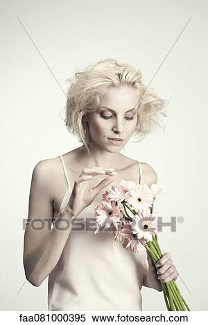 Young woman contemplating bunch of gerbera daisies View Large Photo Image Stock Photography - Young woman contemplating bunch of gerbera daisies. Fotosearch
