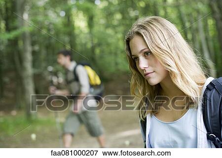 Young woman hiking in woods View Large Photo Image Stock Photo - Young woman hiking in woods. Fotosearch