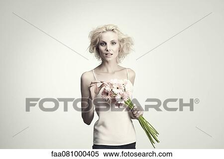 Young woman holding bunch of gerbera daisies View Large Photo Image Stock Photography - Young woman holding bunch of gerbera daisies. Fotosearch