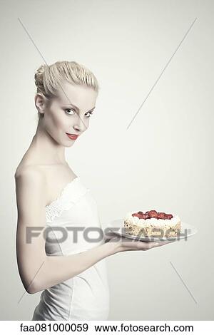 Young woman holding strawberry cake, portrait View Large Photo Image Stock Photo - Young woman holding strawberry cake, portrait. Fotosearch