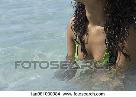 Young woman in bikini in water, mid section View Large Photo Image Picture - Young woman in bikini in water, mid section. Fotosearch
