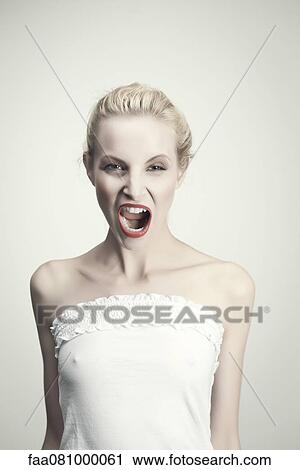 Stock Image - Young woman shouting, portrait. Fotosearch