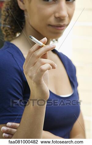 Young woman smoking cigarette View Large Photo Image Stock Image - Young woman smoking cigarette. Fotosearch