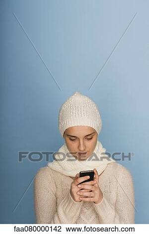 Young woman text messaging with cell phone View Large Photo Image Stock Image - Young woman text messaging with cell phone. Fotosearch