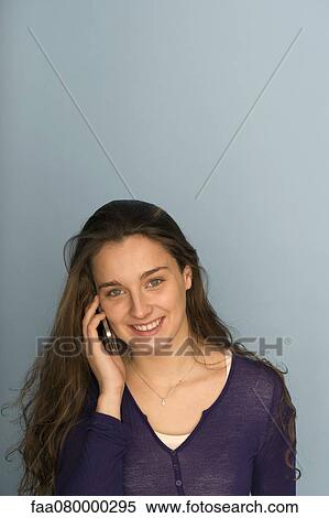 Young woman using cell phone View Large Photo Image Stock Photography - Young woman using cell phone. Fotosearch