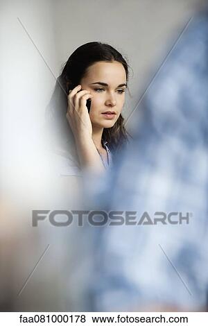 Young woman using cell phone with concerned expression View Large Photo Image Stock Photo - Young woman using cell phone with concerned expression. Fotosearch