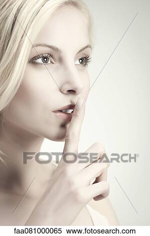 Young woman with finger on lips View Large Photo Image Stock Photography - Young woman with finger on lips. Fotosearch