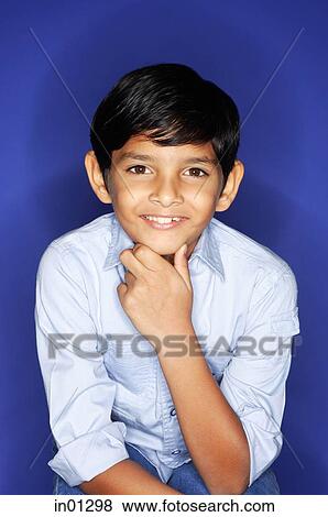 Boy looking at camera, hand on chin View Large Photo Image Stock Photo - Boy looking at camera, hand on chin. Fotosearch