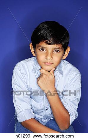 Boy looking at camera, hand on chin, portrait View Large Photo Image Stock Photo - Boy looking at camera, hand on chin, portrait. Fotosearch