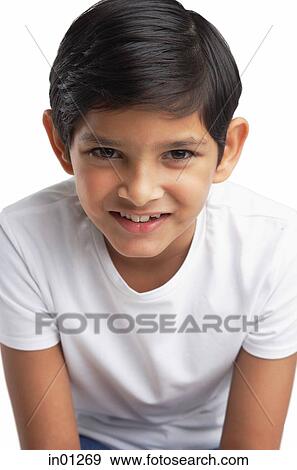 Stock Photo - Boy looking at camera, head shot. Fotosearch