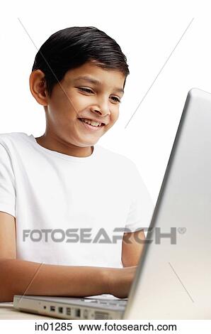 Boy using laptop, smiling View Large Photo Image Stock Photography - Boy using laptop, smiling. Fotosearch
