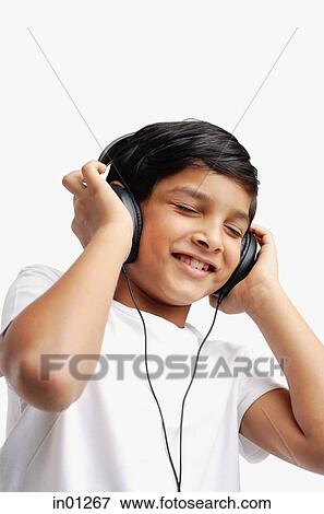 Boy wearing headphones, eyes closed View Large Photo Image Stock Photo - Boy wearing headphones, eyes closed. Fotosearch