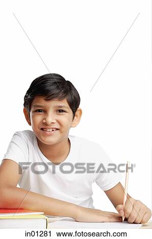 Boy with book and pencil, looking at camera View Large Photo Image Stock Image - Boy with book and pencil, looking at camera. Fotosearch