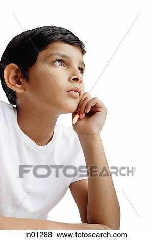 Boy with hand on chin, looking away View Large Photo Image Stock Photo - Boy with hand on chin, looking away. Fotosearch