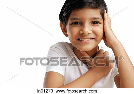 Boy with hand on chin, portrait View Large Photo Image Stock Photo - Boy with hand on chin, portrait. Fotosearch