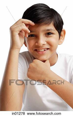 Boy with hand on chin, smiling View Large Photo Image Stock Photo - Boy with hand on chin, smiling. Fotosearch