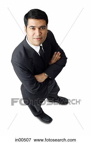 Stock Photo - Businessman, arms crossed, looking at camera, portrait. Fotosearch