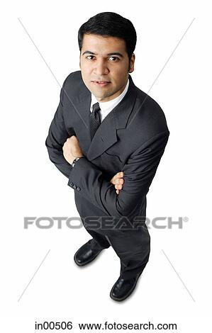 Businessman, arms crossed, looking up at camera View Large Photo Image Stock Photograph - Businessman, arms crossed, looking up at camera. Fotosearch