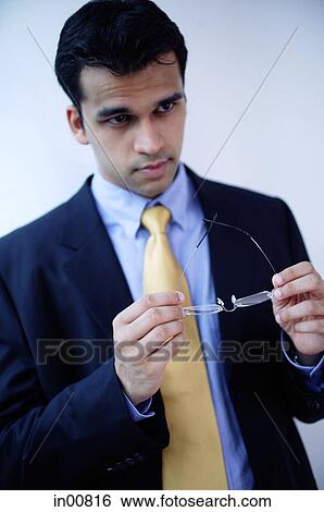 Businessman holding glasses View Large Photo Image Stock Photograph - Businessman holding glasses. Fotosearch