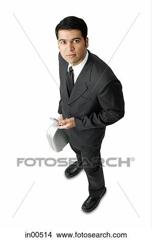 Picture - Businessman, holding mobile phone and briefcase. Fotosearch