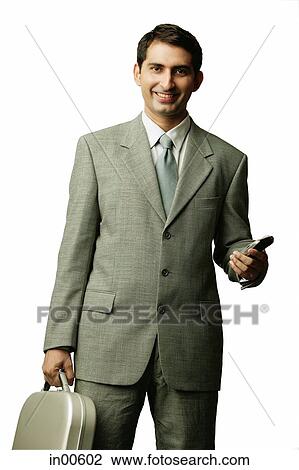Businessman holding mobile phone and briefcase, looking at camera View Large Photo Image Stock Image - Businessman holding mobile phone and briefcase, looking at camera. Fotosearch