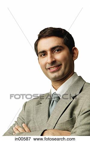 Businessman, looking at camera, arms crossed View Large Photo Image Stock Photo - Businessman, looking at camera, arms crossed. Fotosearch