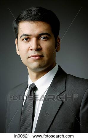 Stock Image - Businessman looking at camera, portrait. Fotosearch
