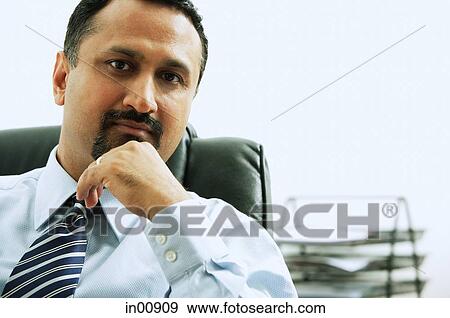 Stock Photo - Businessman looking at camera, portrait. Fotosearch