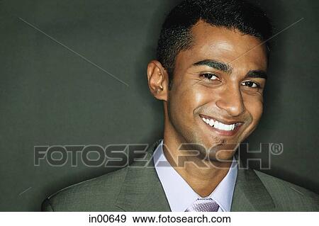 Businessman looking at camera, smiling View Large Photo Image Stock Photo - Businessman looking at camera, smiling. Fotosearch