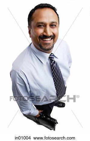 Businessman standing, smiling at camera View Large Photo Image Picture - Businessman standing, smiling at camera. Fotosearch