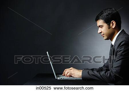 Businessman using laptop View Large Photo Image Stock Photography - Businessman using laptop. Fotosearch