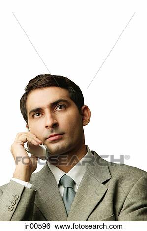 Stock Photograph - Businessman using mobile phone, portrait. Fotosearch