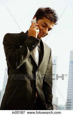 Businessman using mobile phone View Large Photo Image Stock Photo - Businessman using mobile phone. Fotosearch