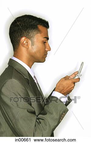Businessman using mobile phone, text messaging View Large Photo Image Stock Image - Businessman using mobile phone, text messaging. Fotosearch