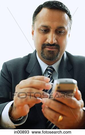 Businessman using PDA phone View Large Photo Image Stock Image - Businessman using PDA phone. Fotosearch