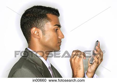 Businessman using PDA, side view View Large Photo Image Stock Image - Businessman using PDA, side view. Fotosearch