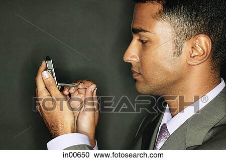 Stock Image - Businessman using PDA. Fotosearch