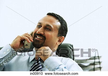 Stock Image - Businessman using telephone. Fotosearch