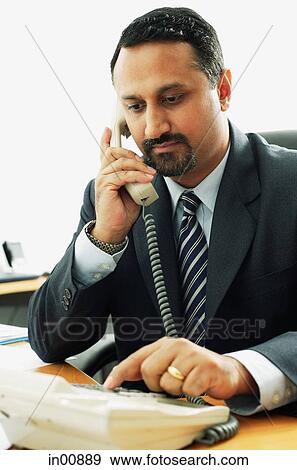 Stock Photo - Businessman using telephone. Fotosearch