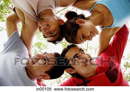 Circle of friends, arms around each other, looking away View Large Photo Image Stock Photography - Circle of friends, arms around each other, looking away. Fotosearch